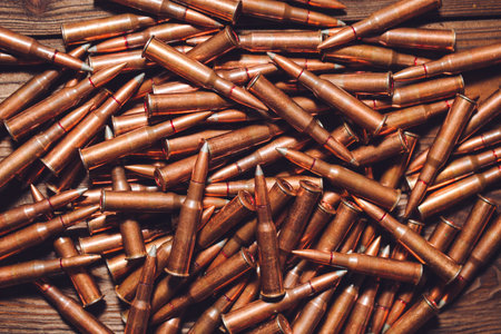 Bullets on a wooden background. Military concept.