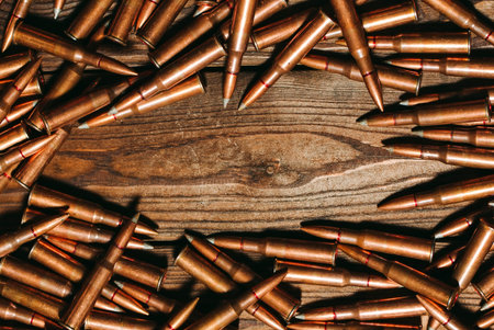 Bullets on a wooden background. Military concept.