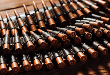 Bullets on a wooden background. Military concept.の写真素材