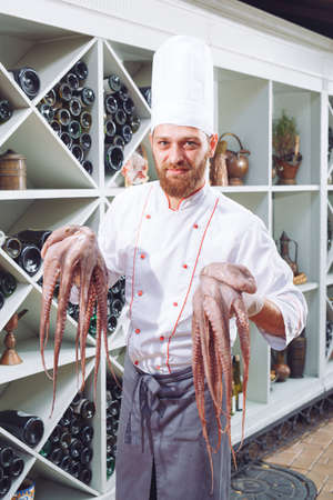 The chef is holding and cooks an octopus.の写真素材