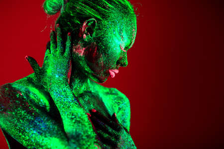 Portrait of a girl painted in fluorescent powder.の写真素材