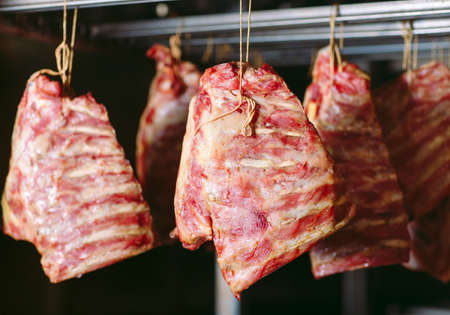 smoking meat in the smokehouse, the meat industry.の写真素材