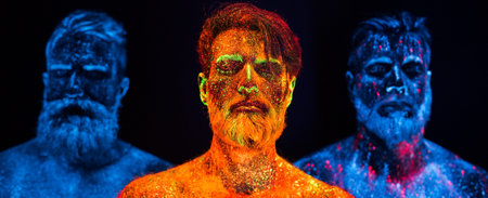 Portrait of three bearded men painted in florescent powdersの写真素材