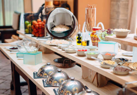 buffet in a restaurant or hotel. Metal dishes with caps.の写真素材