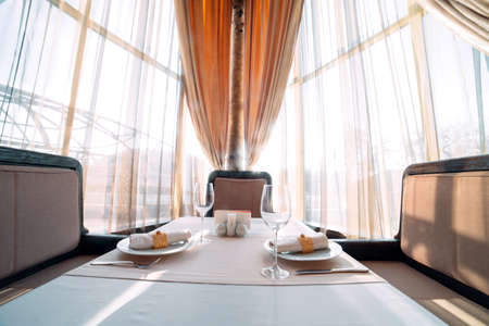 Served table for two persons in a trendy restaurant.の写真素材