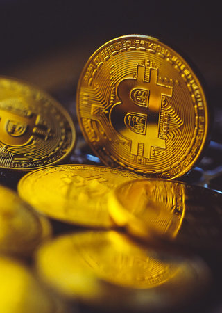 Bitcoin coins on laptop keyboard. Cryptocurrency
