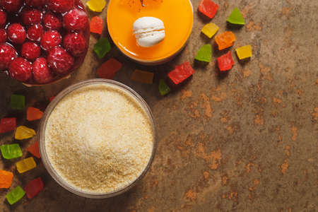 Gelatin and candied fruit on the wooden backgrounde. Top view.の写真素材