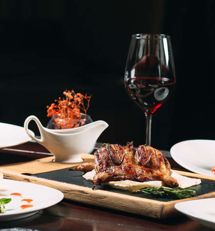 Grilled partridge, sea bass, Tartarus. Different dishes on the table in the restaurantの写真素材