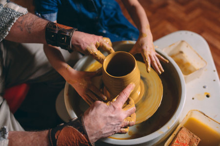 Pottery workshop. Grandpa teaches granddaughter pottery. Clay modeling