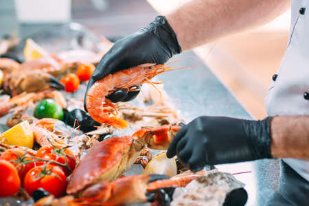 The Chef puts the seafood on a tray in the restaurant.の写真素材