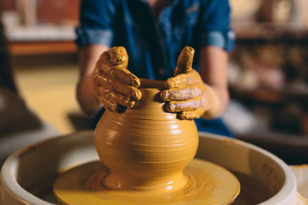 Pottery workshop. A little girl makes a vase of clay. Clay modelingの写真素材