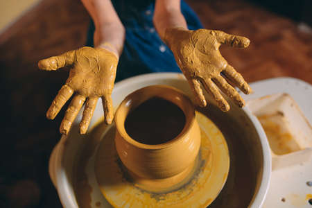 Pottery workshop. A little girl makes a vase of clay. Clay modelingの写真素材