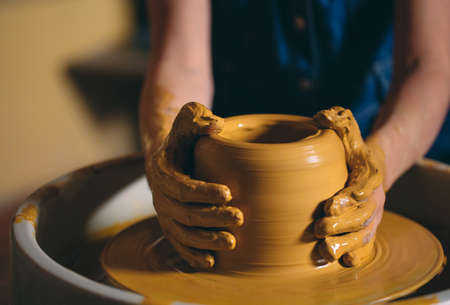 Pottery workshop. A little girl makes a vase of clay. Clay modelingの写真素材