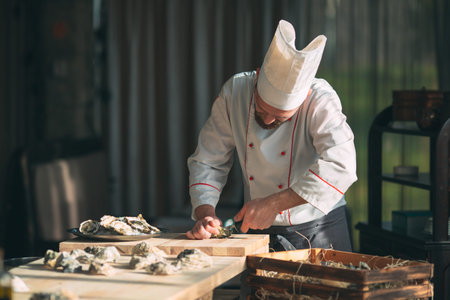 Opening the hollow and flat oysters. Chef opens oysters in the restaurant.