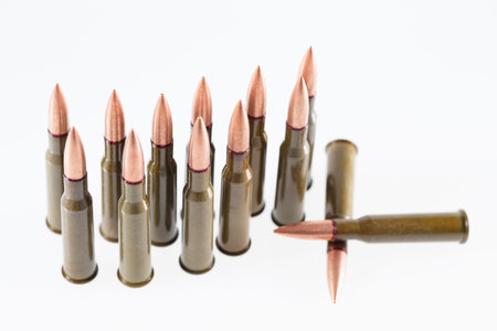 Military 7.62 mm cartridge on a white background.