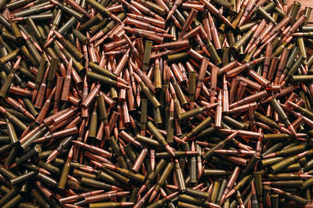 A lot of different ammo on a wooden background.の写真素材