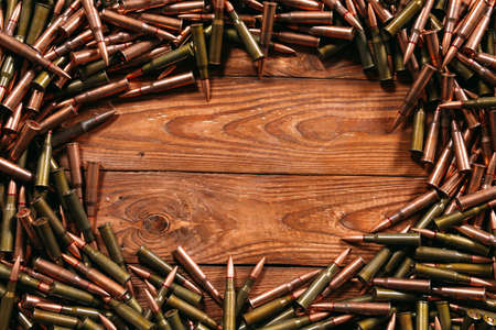 A lot of different ammo on a wooden background.の写真素材