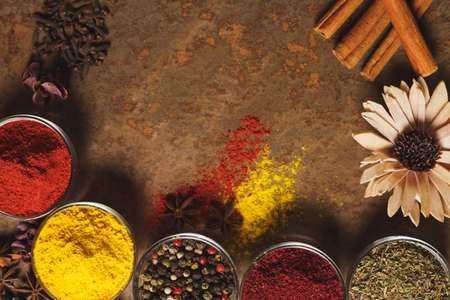 Different types of Spices in a bowl on a stone background. The view from the top. Place for text.の写真素材