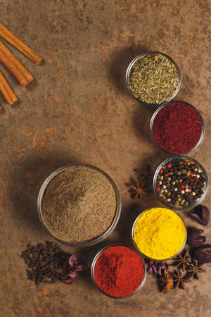 Ground Black Pepper. Place for text. Different types of Spices in a bowl on a stone background. The view from the top.の写真素材