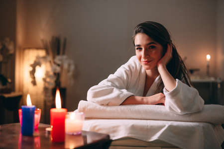 Spa, massage. A young dark-haired beautiful girl is waiting for a massage.の写真素材