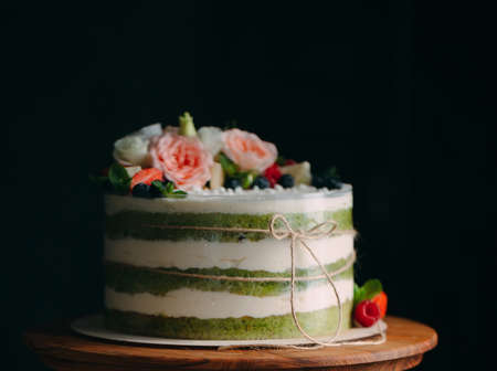 Cake is decorated with flowers on a dark backgroundの写真素材