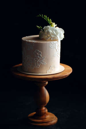 Cake is decorated with flowers on a dark background.の写真素材
