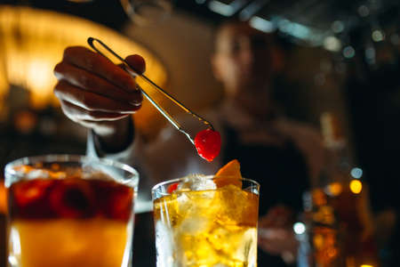 The bartender prepares cocktails at the bar.の写真素材