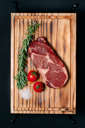 Rib eye steak on a black background.
