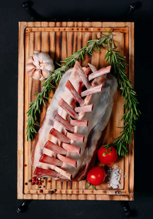 A rack of new Zealand Lamb in raw form on a black background.の写真素材
