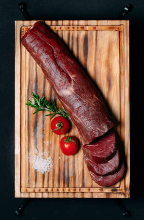 Raw tenderloin meat on a black background.の写真素材