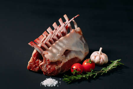 A rack of new Zealand Lamb in raw form on a black background.の写真素材