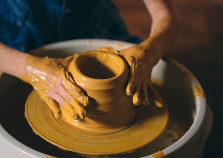 Pottery workshop. A little girl makes a vase of clay. Clay modelingの写真素材