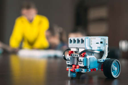 Kids creating robots with teacher. Early development, diy, innovation, modern technology concept.の写真素材