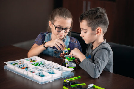 Children in the classroom collect figure from the designer.