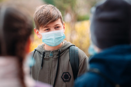 School-age children in medical masks. portrait of school children.