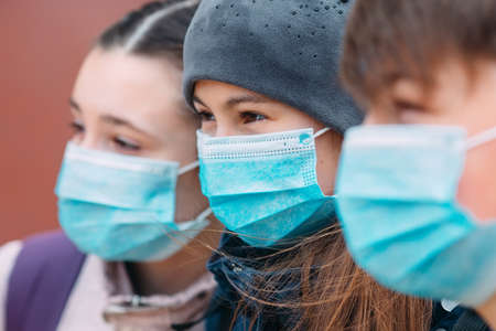 School-age children in medical masks. portrait of school children.の写真素材