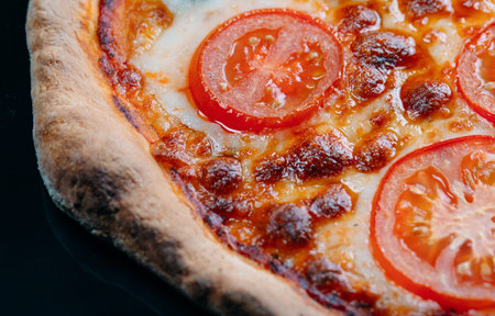 pizza Margarita close up with cheese and tomatoes.