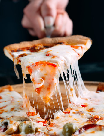 Pizza with very much cheese melting.