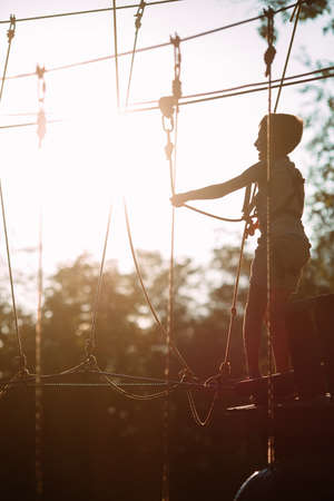 rope park. A boy passes an obstacle on tires in a rope Park.の写真素材