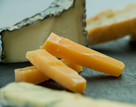 Various types of cheese with grapes and tomatoesの写真素材