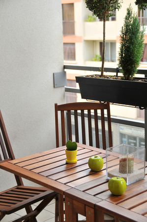 terrace with wooden table and two chairs and decorの写真素材