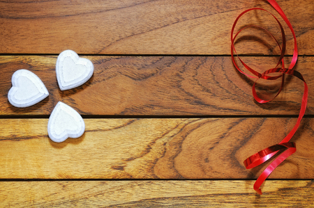 hearts forming a clover with wood and red ribbonの写真素材
