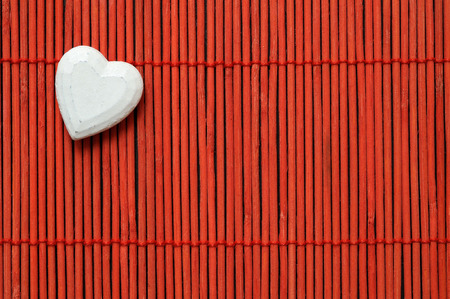 white heart on red bamboo top left cornerの写真素材