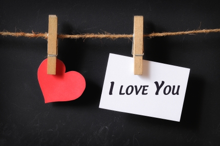 heart with i love you poster hanging with blackboard backgroundの写真素材