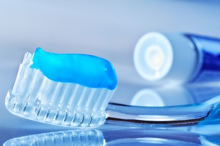 toothbrush on the table with toothpaste and toothpaste tubeの写真素材