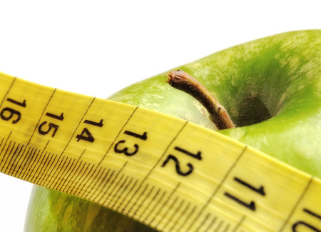 apple and measuring tape isolated for a healthy lifestyleの写真素材