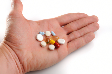 group offered pills on hand with white backgroundの写真素材