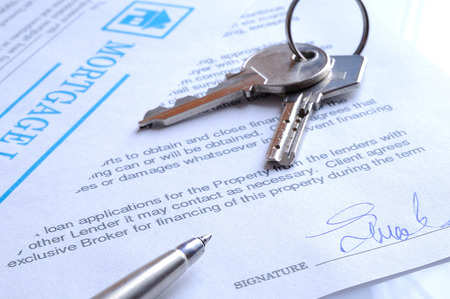 mortgage contract signed with detail of keys to buying a home closeupの写真素材