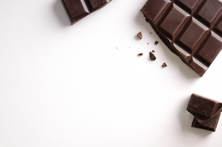 Broken chocolate bar isolated on white table. Horizontal composition. Top viewの写真素材