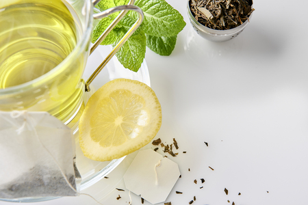 Glass cup green tea with mint and lemon, and teabag on a table in the living room close up. Horizontal composition. Top view.の写真素材